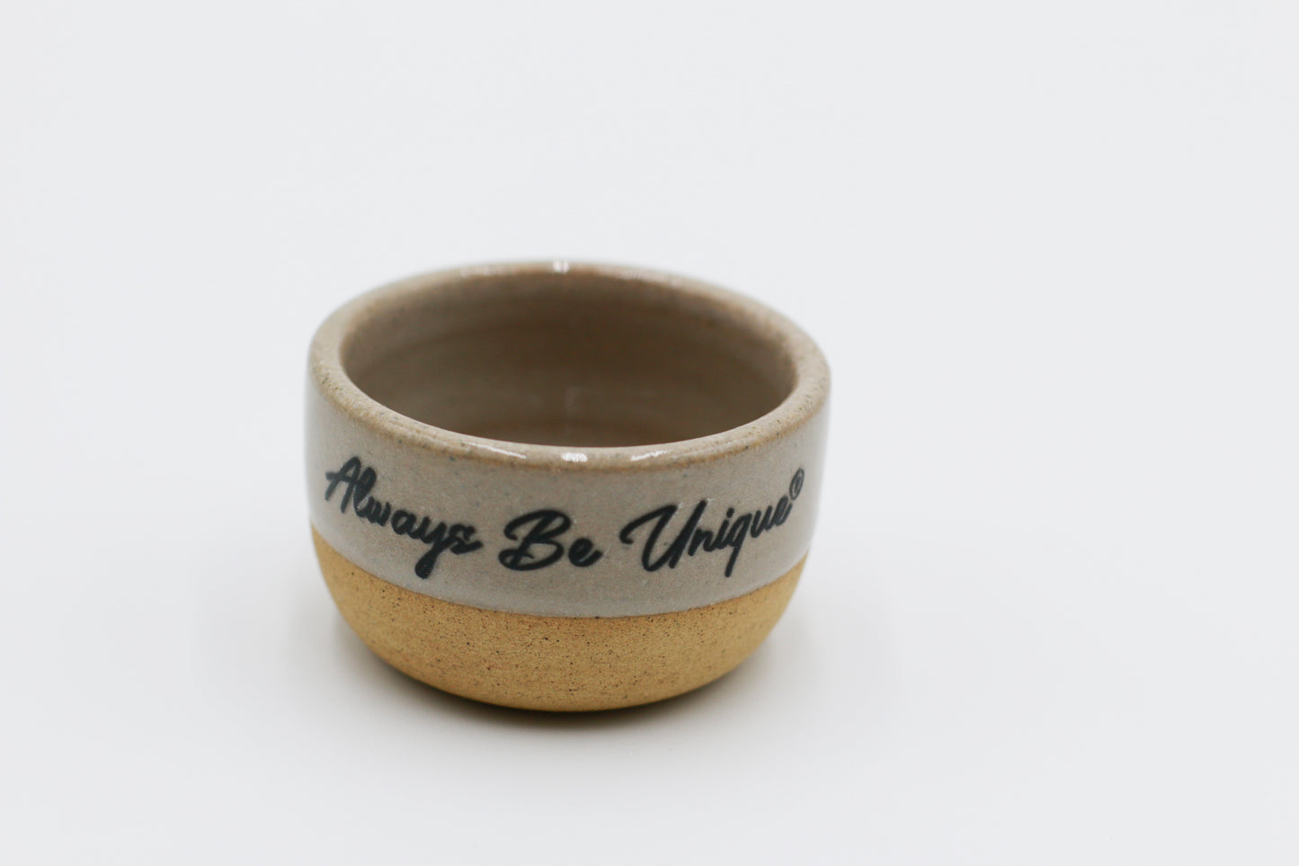 Small ceramic bowl with 'Always Be Unique' text on a white background